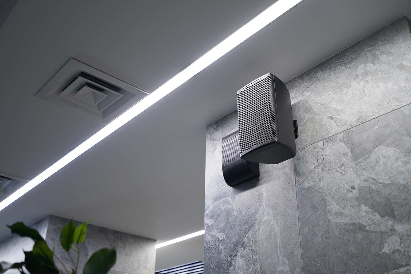 A set of small speakers mounted on a wall