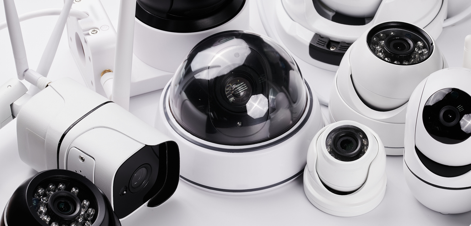 A group of different security cameras on a table