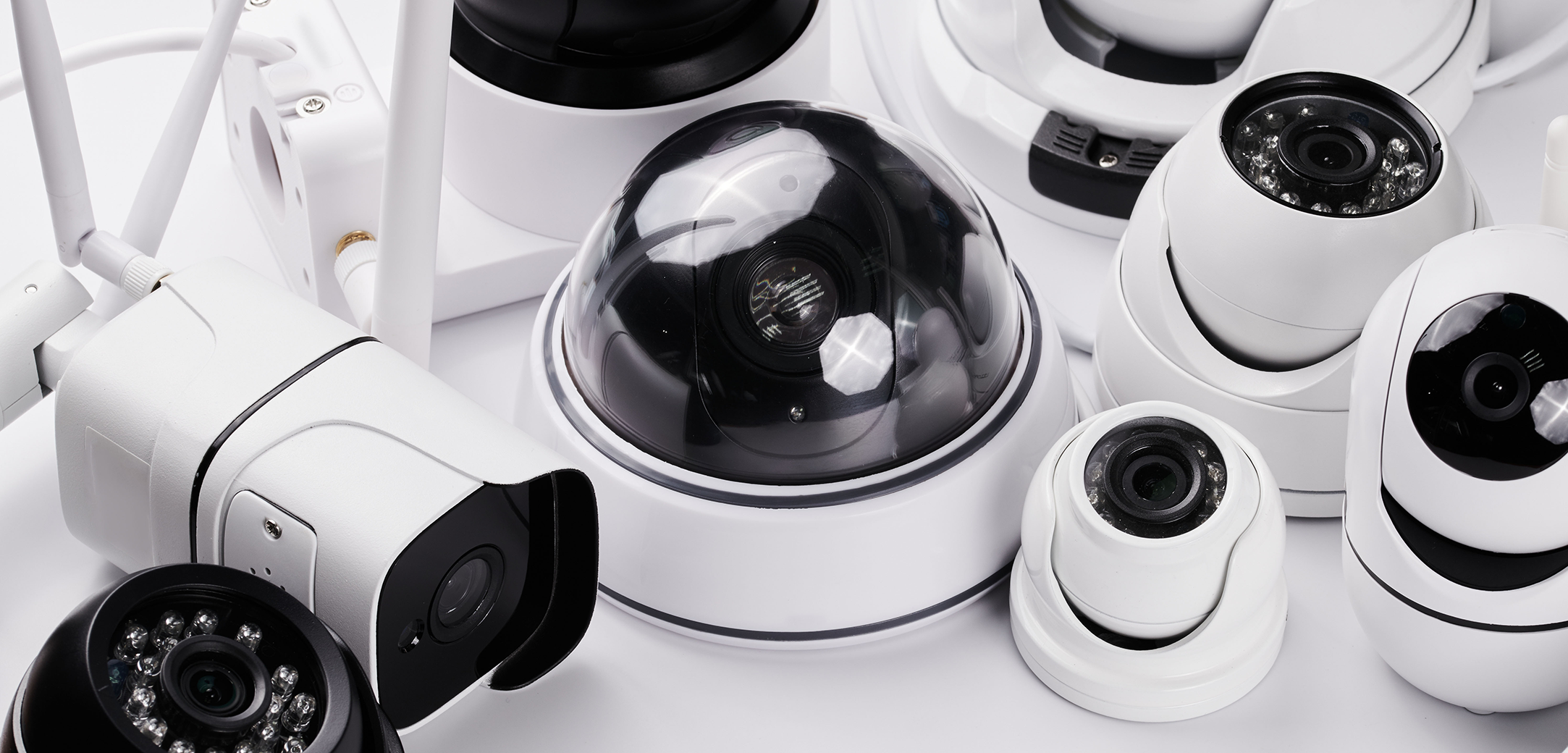 A group of different security cameras on a table