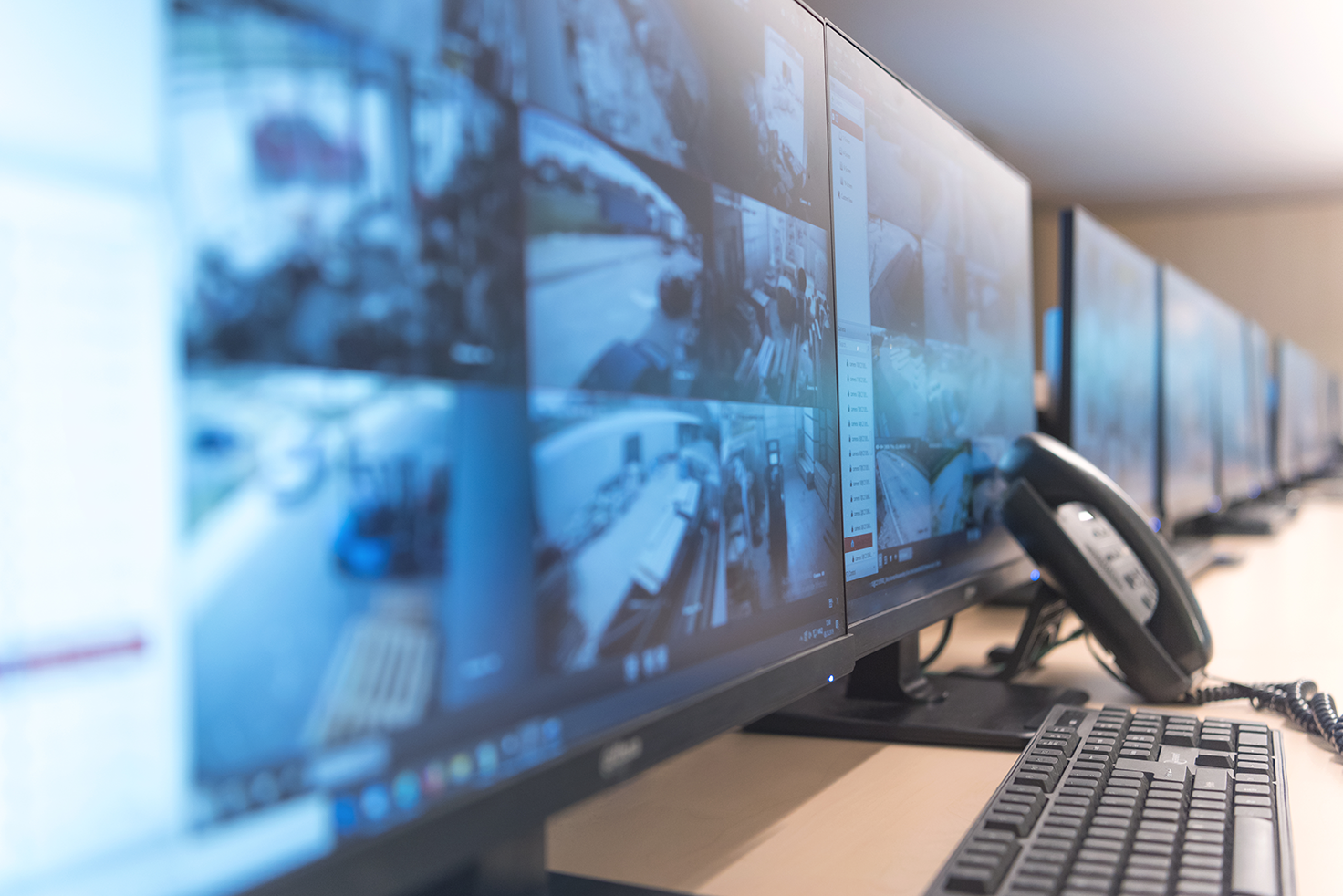 A row of computer screens showing security camera footage